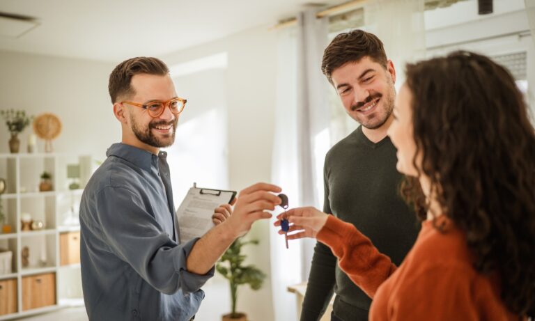Letting agent handing over keys to tenants in an Ipswich buy-to-let property during a rental agreement