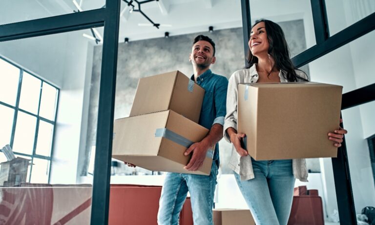 Young couple carrying moving boxes into a modern Chelmsford rental property under the Renters’ Rights Act 2026