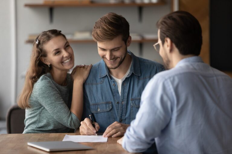 Young couple discussing a property sale with an estate agent in Chelmsford covering CM1 and CM2 housing markets