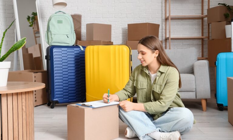 Young tenant surrounded by moving boxes and luggage while preparing to move into a rental home in Bury St Edmunds