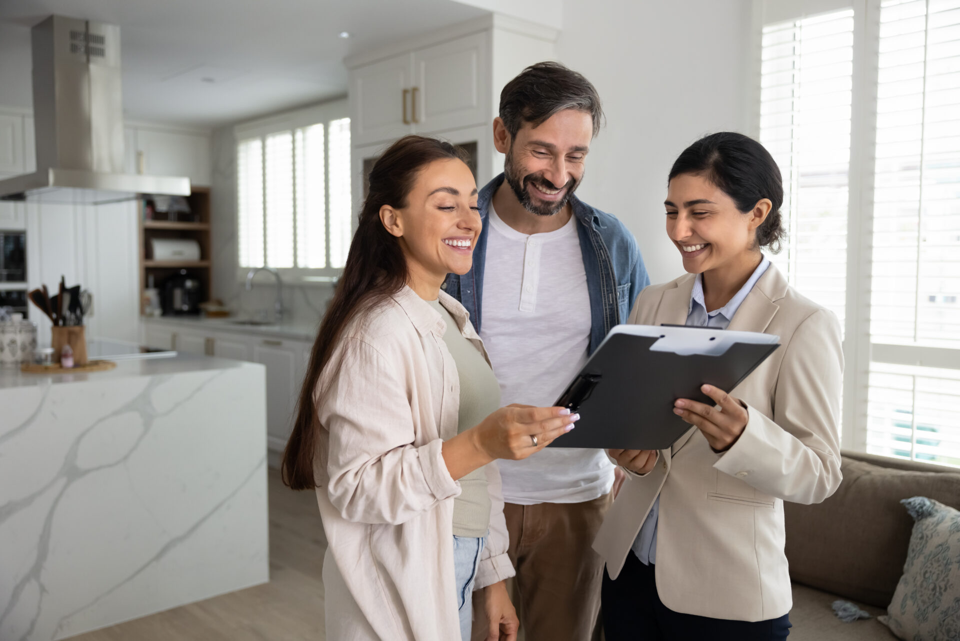 Letting agent reviewing property details with a couple, representing Shrewsbury buy-to-let areas and rental yield advice.