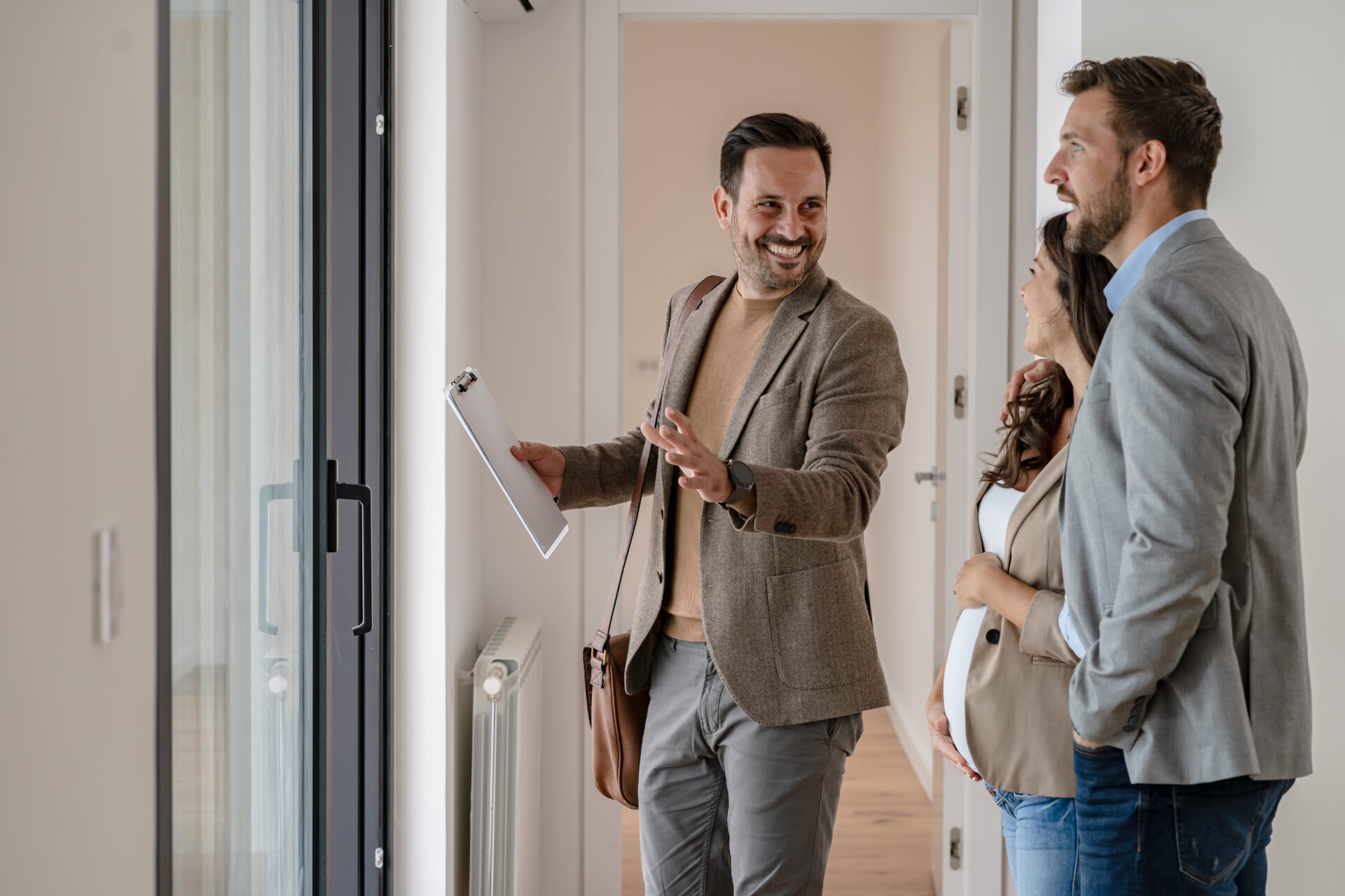 Letting agent showing a property to prospective tenants during a house viewing, representing landlord lettings advice in Christchurch.