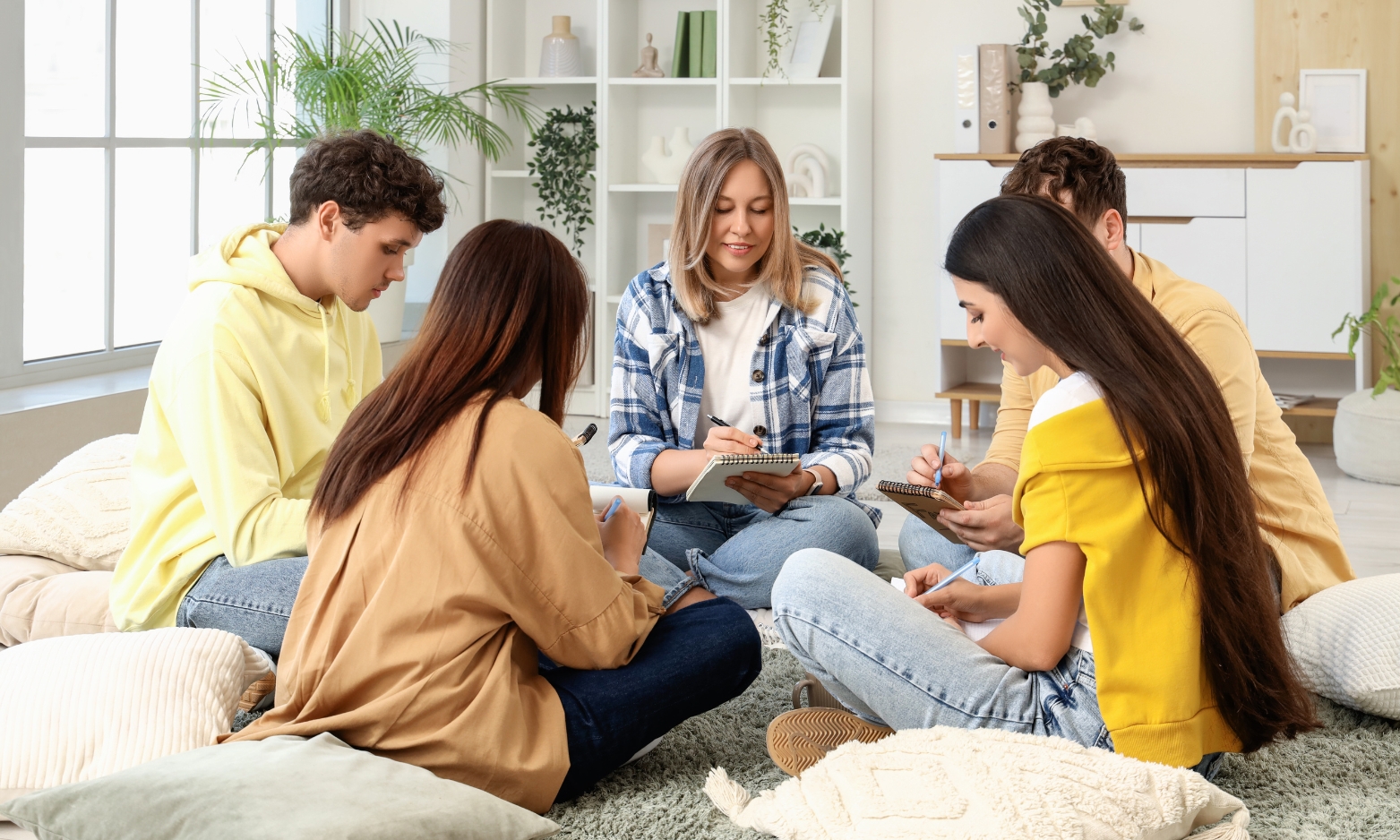 Group of young adults sharing a communal living space, representing house in multiple occupation accommodation in Ipswich