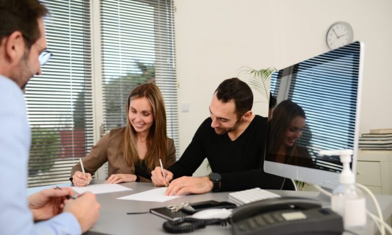 A letting agent from Belvoir Doncaster meets with prospective tenants as they sign a tenancy agreement, illustrating the rental process for tenants and landlords in Rossington DN11.
