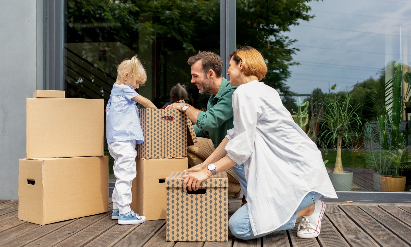 A family moving into a modern home while unpacking moving boxes, illustrating strong demand for quality rental properties in Chelmsford's CM1 and CM2 areas and the opportunities for buy-to-let investors in 2026.