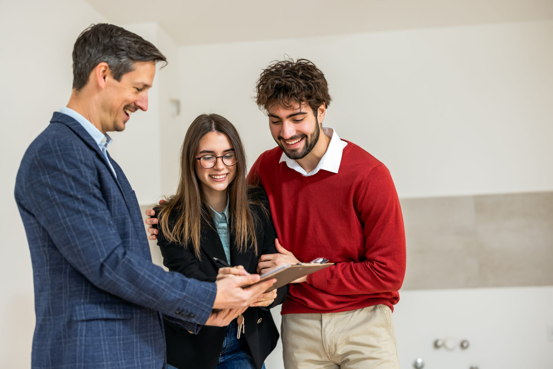 Estate agent reviewing property documents with a young couple buying their first home in Chelmsford.