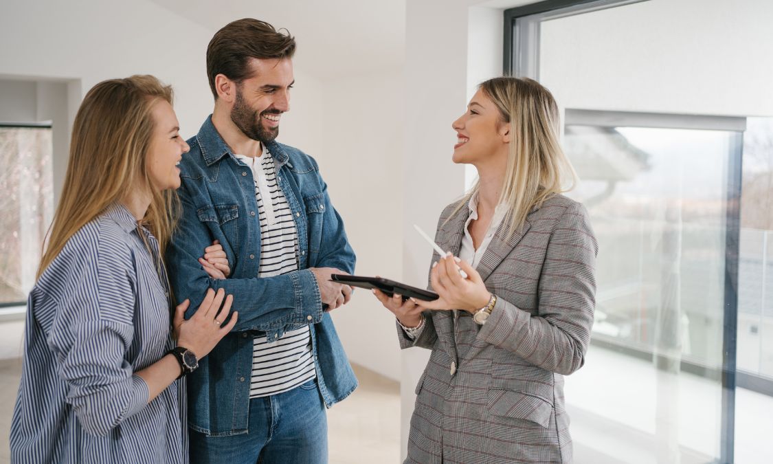 A first-time buyer couple speaking with an estate agent during a property viewing in Haywards Heath, representing the home-buying process and expert guidance for purchasing a first home in 2026.